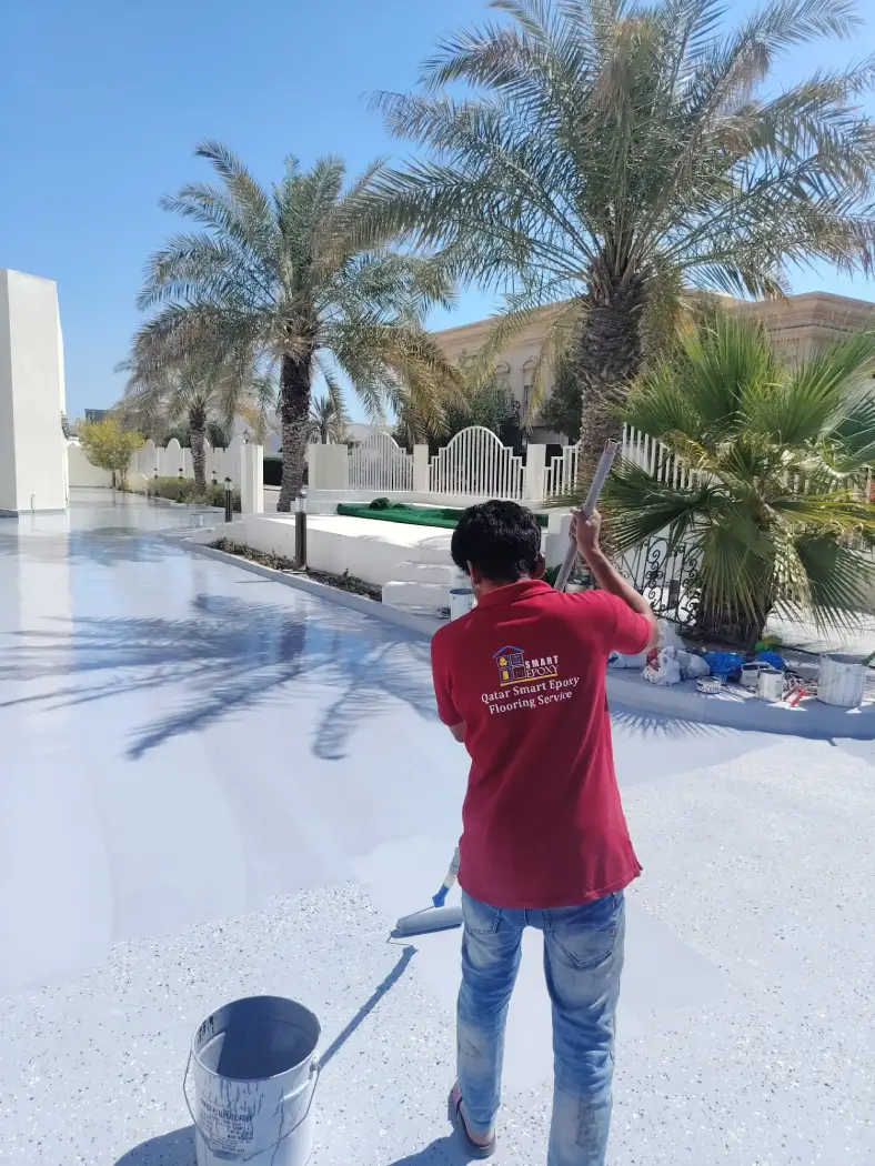 Epoxy floor coating being applied to an outdoor villa surface in Qatar