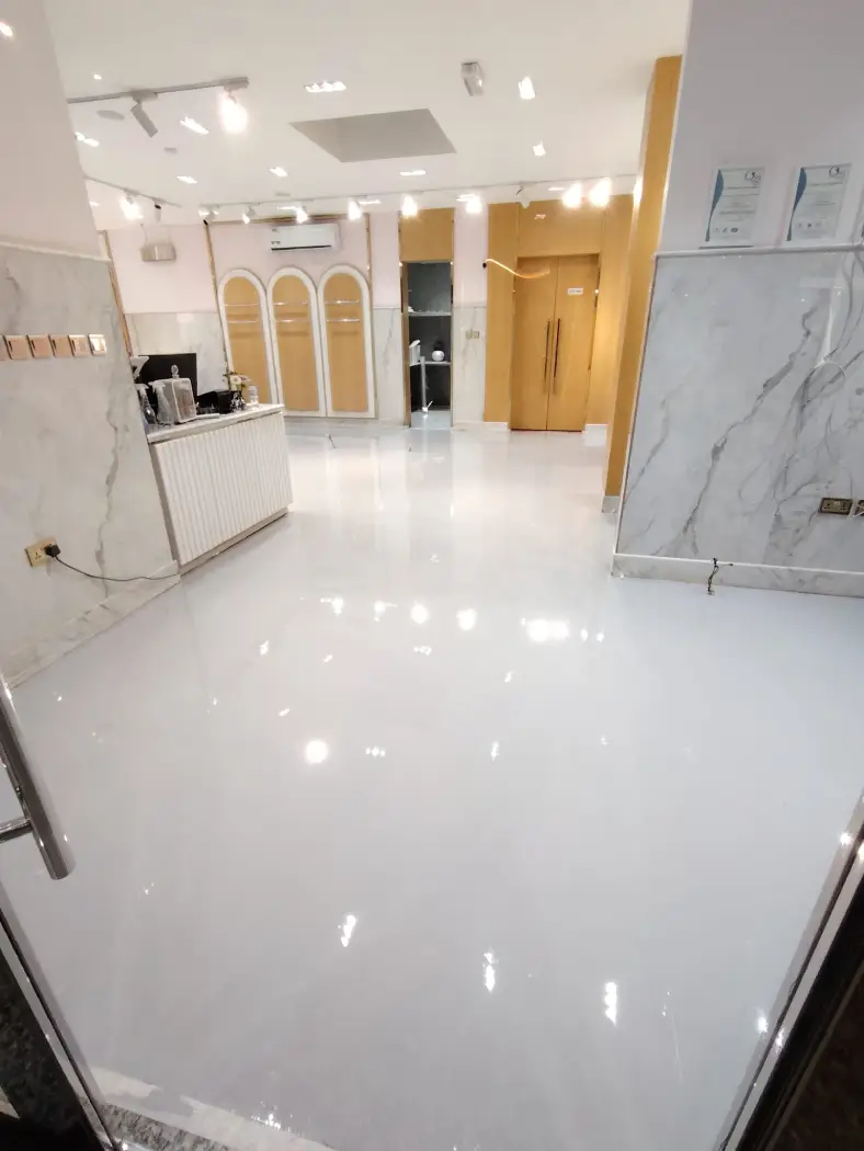 Glossy white epoxy flooring installed in a modern commercial space